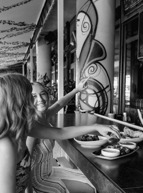 Black and white photo of American Social bar with two girls.
