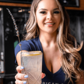 Girl is serving a cocktail.