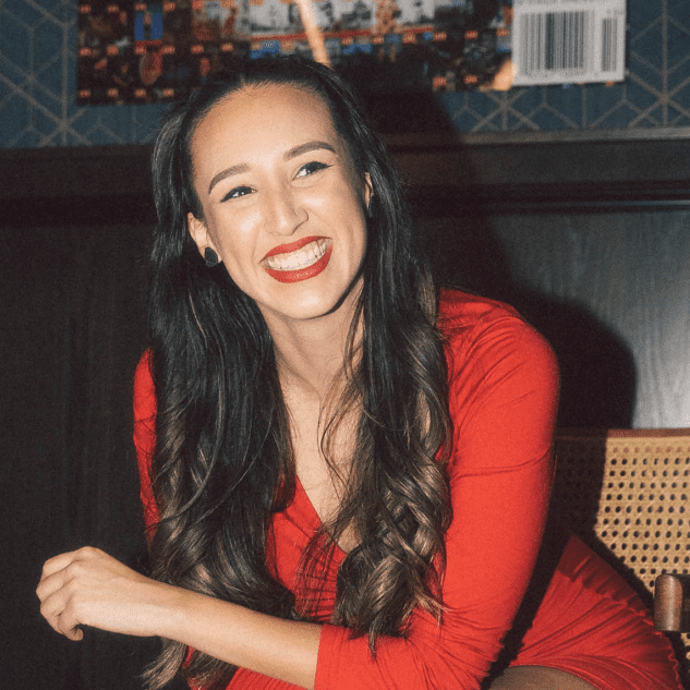 Smiling brown haired woman in a pretty red dress.